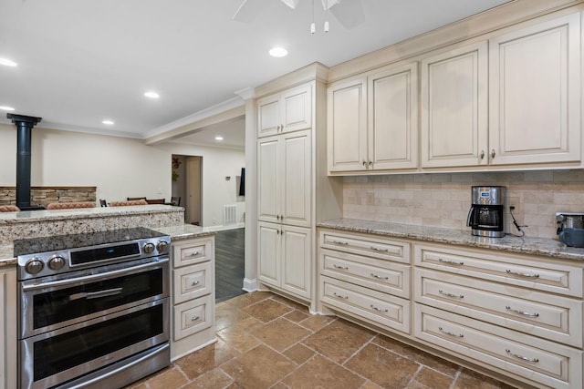 1780 Molly Hollow Rd, Nolensville, TN 37135 - kitchen with light stone countertops, decorative backsplash, crown molding, cream cabinets, and range with two ovens