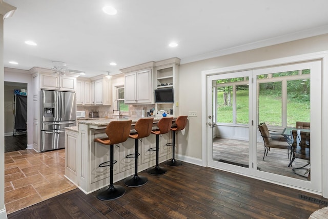 1780 Molly Hollow Rd, Nolensville, TN 37135 - kitchen featuring backsplash, white cabinets, light stone counters, stainless steel fridge with ice dispenser, and a breakfast bar area