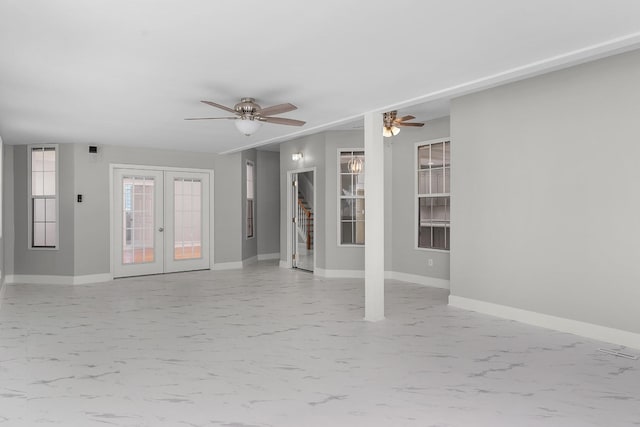 empty room with ceiling fan and french doors