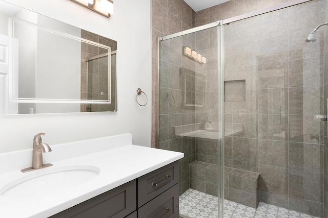 bathroom featuring vanity and a shower with door