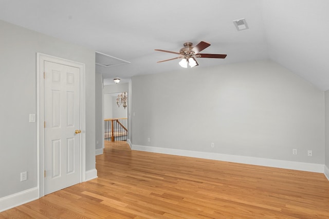 unfurnished room featuring light hardwood / wood-style floors, vaulted ceiling, and ceiling fan