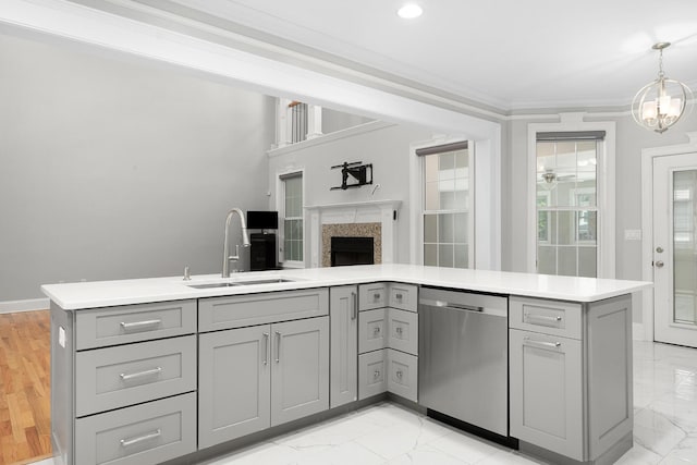 kitchen featuring pendant lighting, crown molding, sink, stainless steel dishwasher, and gray cabinets