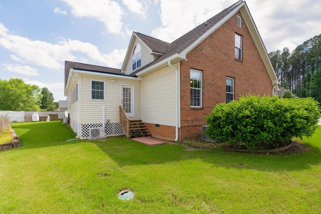 back of property featuring a yard and ac unit