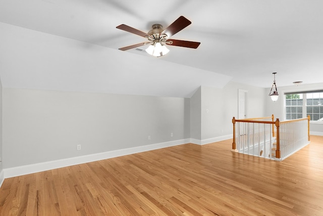 additional living space featuring ceiling fan, light hardwood / wood-style floors, and vaulted ceiling