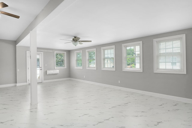 unfurnished room featuring ceiling fan and a wall mounted air conditioner