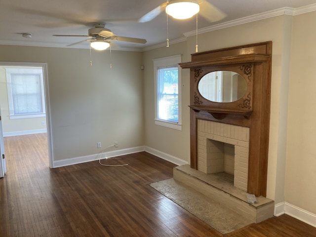 unfurnished living room with crown molding, dark hardwood / wood-style flooring, ceiling fan, and a brick fireplace