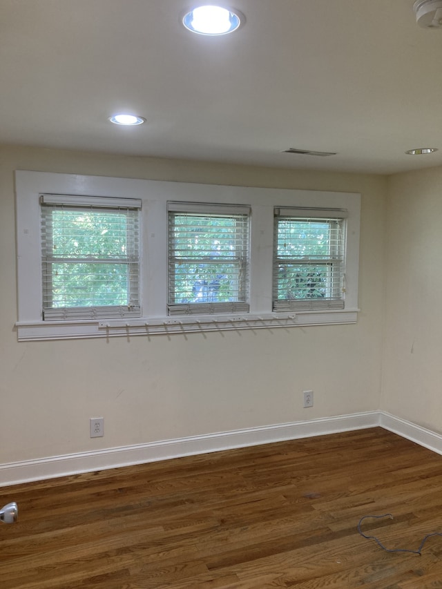 empty room with dark hardwood / wood-style flooring