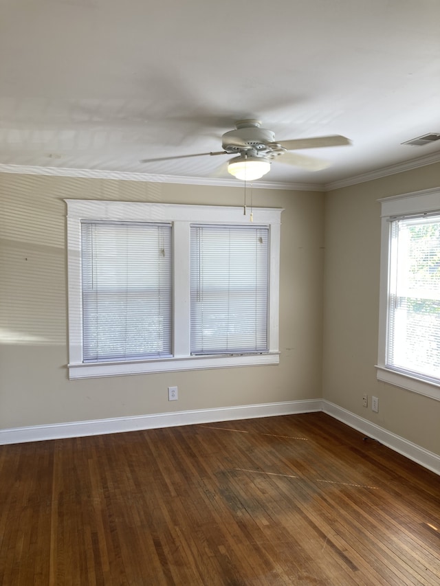 unfurnished room featuring ceiling fan, crown molding, and dark wood-type flooring