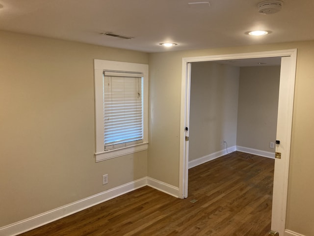 spare room with dark wood-type flooring