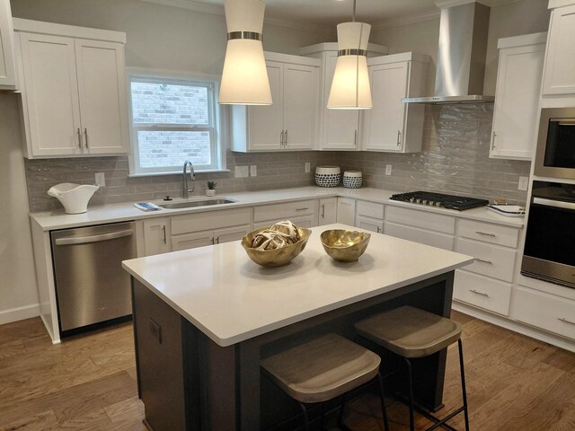 7140 Maddenwood Ln, Hermitage, TN 37076 - kitchen featuring ornamental molding, wall chimney exhaust hood, appliances with stainless steel finishes, and a sink