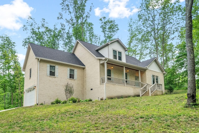 view of front facade with a garage, a porch, and a front lawn