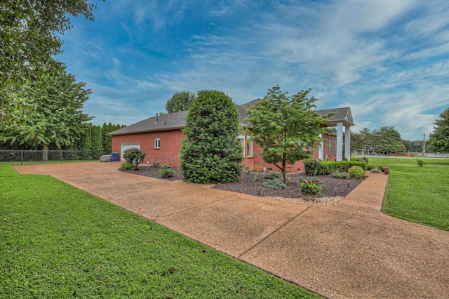 exterior space featuring a garage and a front lawn