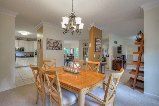 dining space with a textured ceiling, light tile patterned floors, a notable chandelier, and ornamental molding