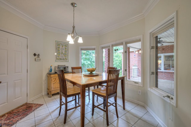 dining room with light tile patterned floors, a wealth of natural light, and crown molding