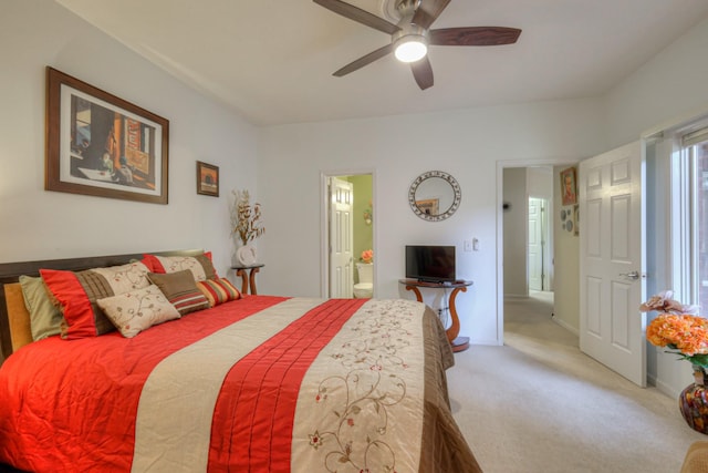 carpeted bedroom featuring connected bathroom and ceiling fan