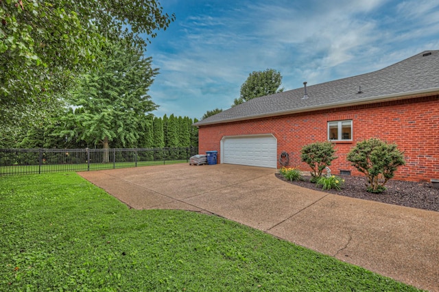 view of home's exterior featuring a garage and a yard