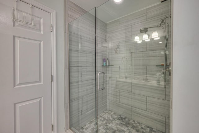 bathroom with a shower with door