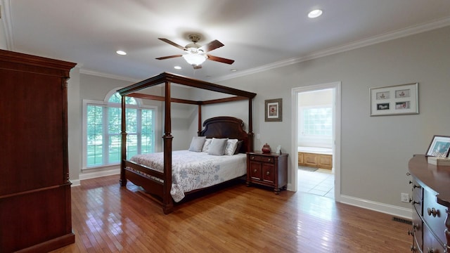 bedroom with multiple windows, connected bathroom, ceiling fan, and ornamental molding