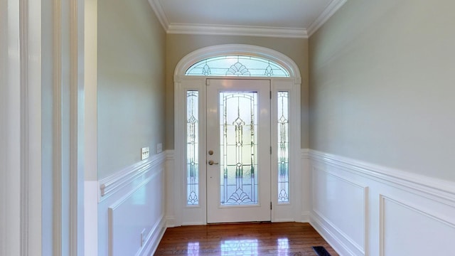 entrance foyer featuring dark hardwood / wood-style floors and ornamental molding