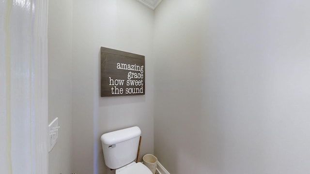 bathroom with ornamental molding and toilet