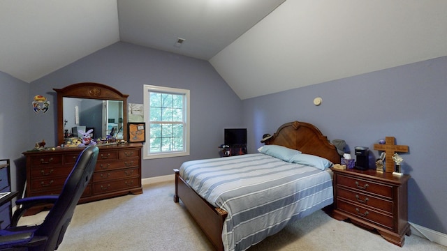 carpeted bedroom with vaulted ceiling