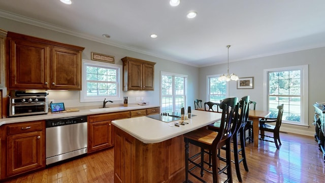 kitchen with dishwasher, an inviting chandelier, sink, an island with sink, and a healthy amount of sunlight