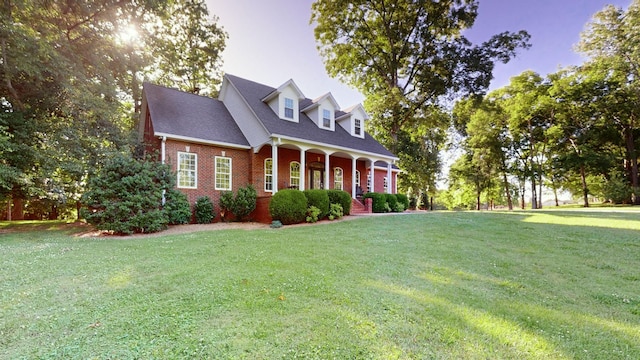 cape cod-style house featuring a yard