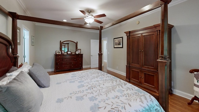 bedroom featuring ceiling fan, wood-type flooring, and ornamental molding