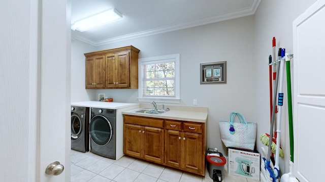 laundry room with cabinets, ornamental molding, sink, washer and dryer, and light tile patterned floors