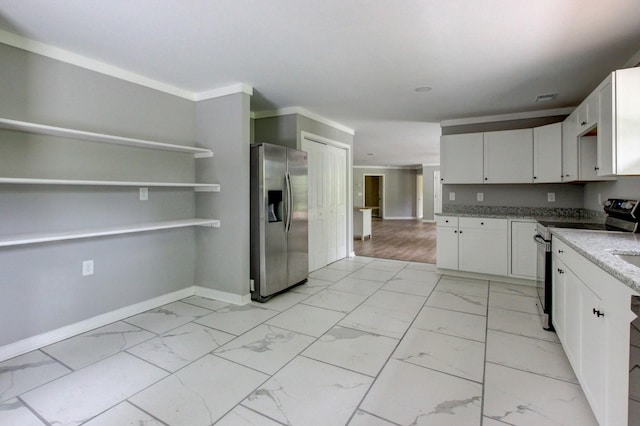 kitchen with light stone countertops, crown molding, white cabinetry, and stainless steel appliances