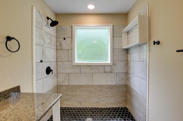 bathroom with a tile shower