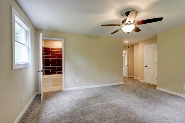 unfurnished bedroom with ceiling fan, light colored carpet, a spacious closet, and a closet