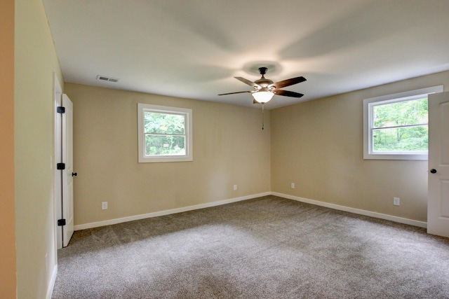 spare room featuring ceiling fan and carpet floors