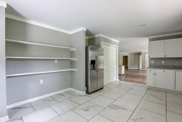 interior space with white cabinets, stainless steel fridge with ice dispenser, stone counters, and crown molding