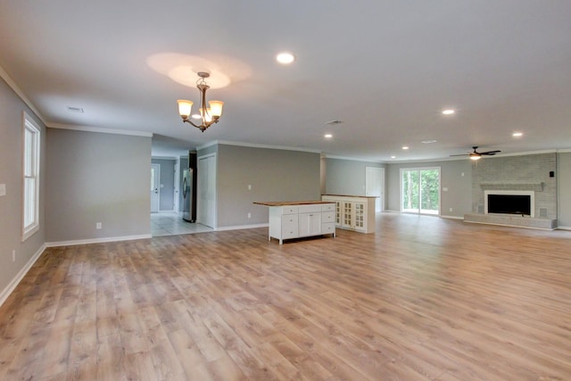 unfurnished living room with a fireplace, light hardwood / wood-style flooring, and ornamental molding