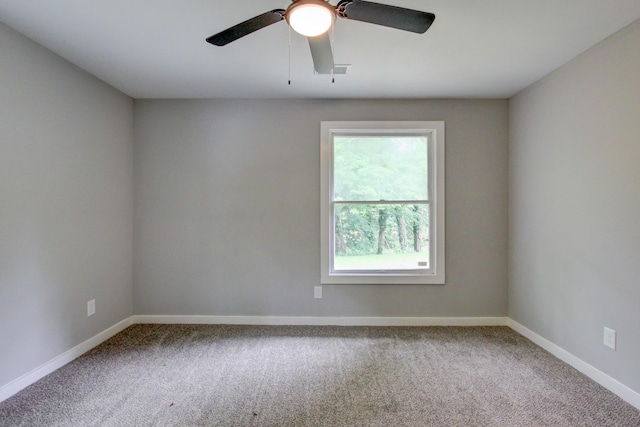 carpeted spare room featuring ceiling fan