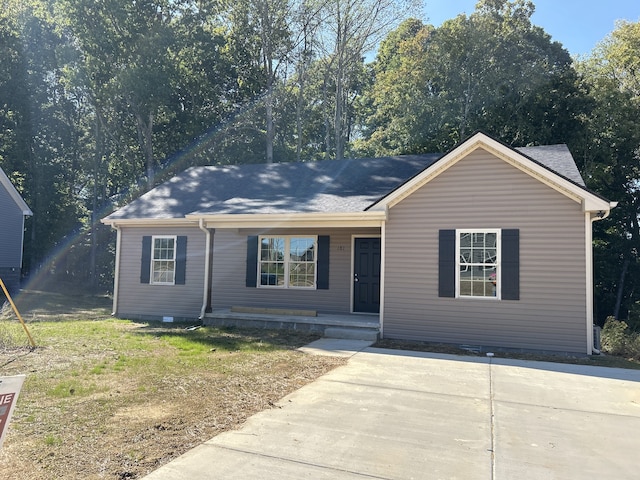 ranch-style house with a front yard and a porch