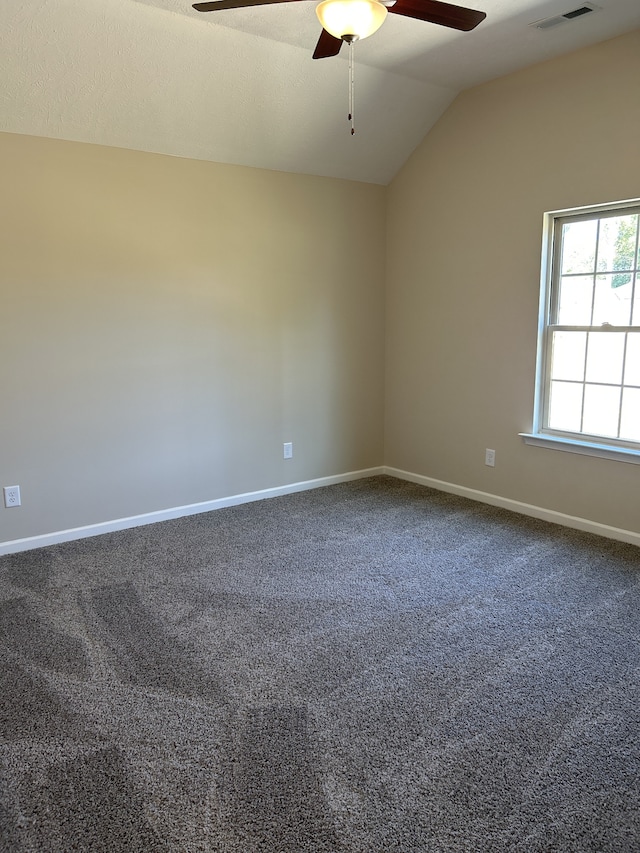 spare room with carpet flooring, ceiling fan, and vaulted ceiling