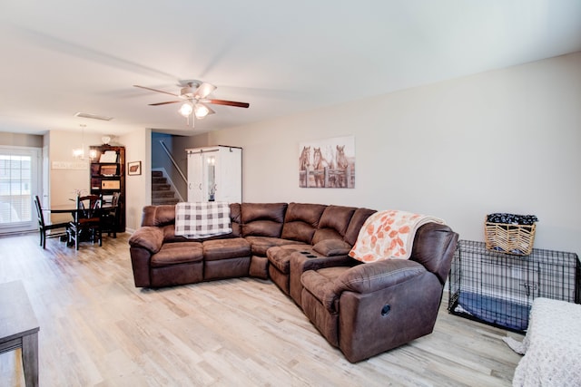 living room featuring hardwood / wood-style flooring and ceiling fan