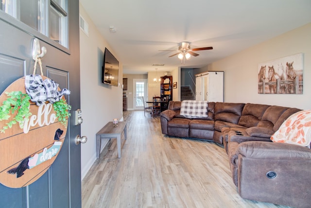 living room with light wood-type flooring and ceiling fan