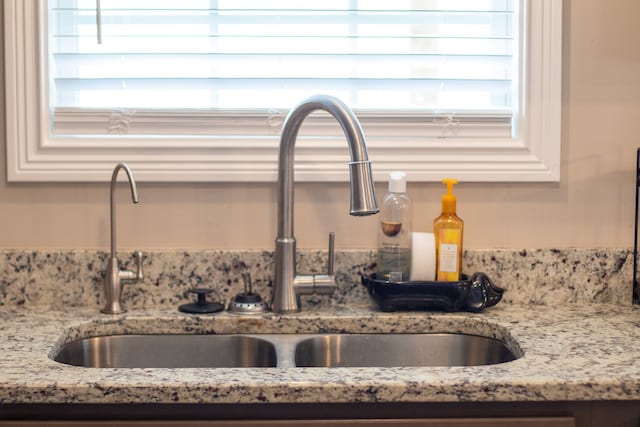 room details with light stone counters and sink