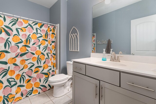 bathroom with tile patterned flooring, vanity, and toilet