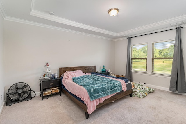 bedroom featuring light carpet, a tray ceiling, and ornamental molding