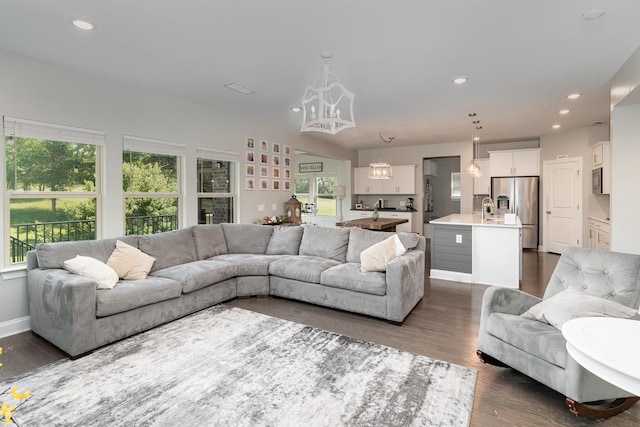 living room featuring dark hardwood / wood-style flooring and a chandelier