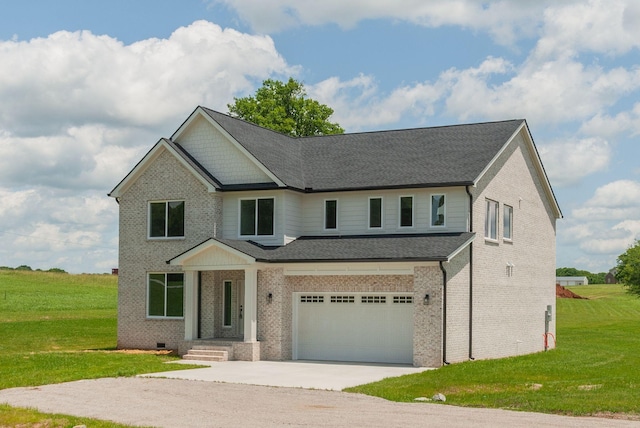 view of front of home with a garage and a front lawn