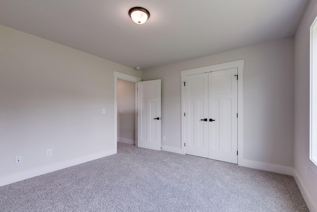 unfurnished bedroom with a closet and carpet floors