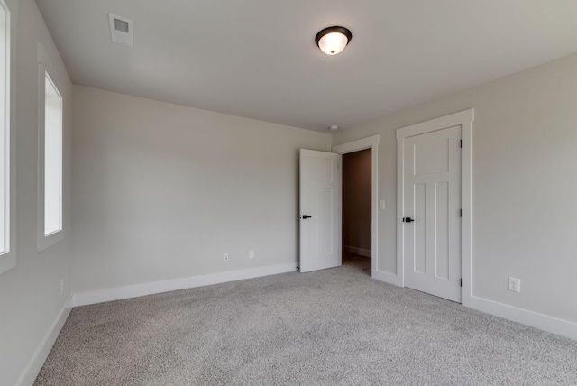 empty room featuring light colored carpet