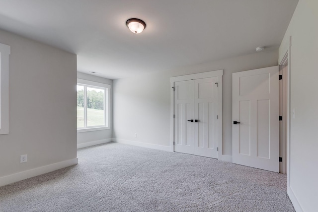 unfurnished bedroom with carpet flooring and a closet