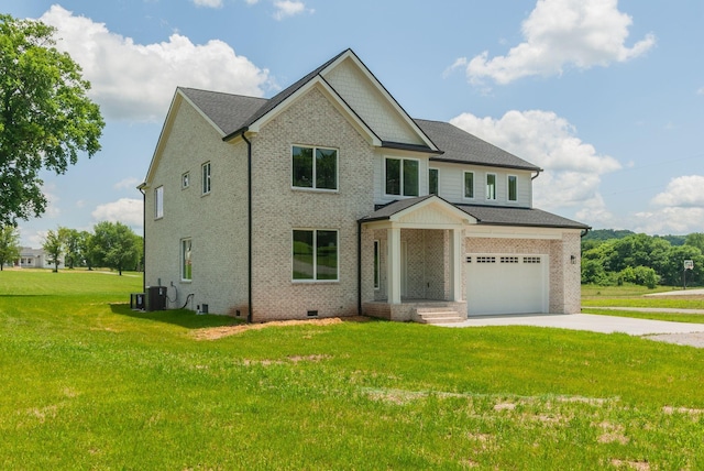 view of front of property with central AC, a front lawn, and a garage