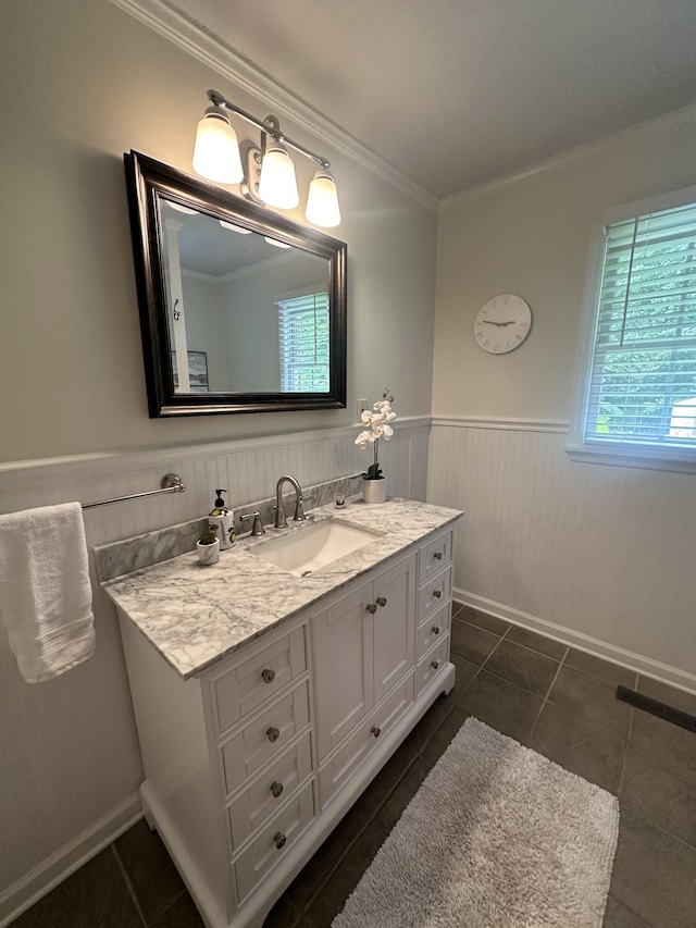 bathroom featuring tile patterned flooring, vanity, and crown molding